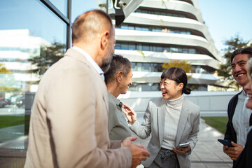 Business team networking outdoors near modern office building