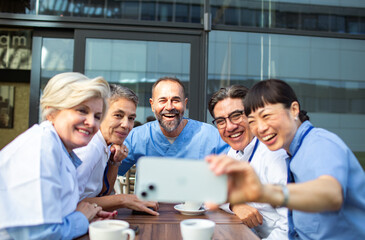 Medical team having a coffee break and sharing a laugh together