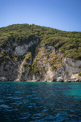 Vertical Landscape of Rock Formation with Green Trees and Turquoise Water in Greece. Beautiful Summer Scenery of Rocky Cliff and Ionian Sea in Zakynthos.