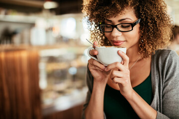 Young woman enjoying a coffee at a cafe