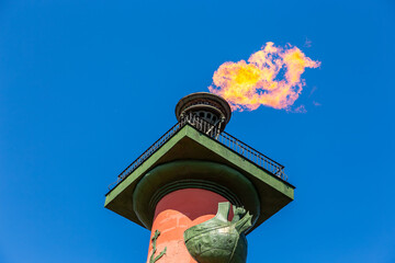 Burning flames on the Rostral columns. Burning rostral columns against the sky in honor of the victory over fascism. Victory Day is May 9th. The fire of the Rostral columns in St. Petersburg, Russia. 