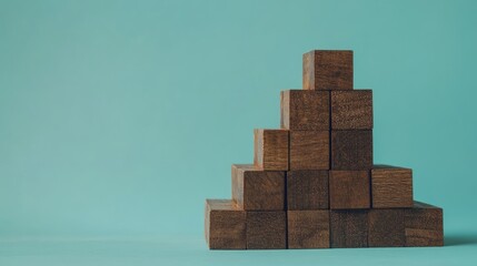 Creative Cube Stacking: Hand-Arranged Wood Blocks for Business Growth Against a Blue Backdrop