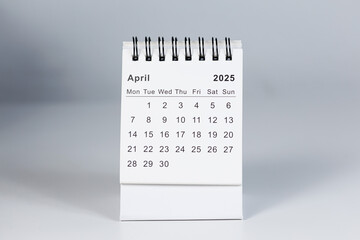 Minimalistic photo of a desk calendar displaying April 2025. Clean and professional design, suitable for topics like planning, organization, and productivity.