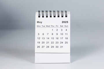 Minimalistic photo of a desk calendar displaying May 2025. Clean and professional design, suitable for topics like planning, organization, and productivity.