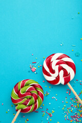 Christmas Candy on blue background. Sweet lollipop. Vertical photo