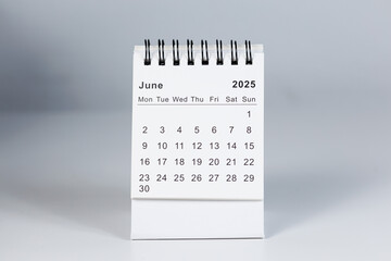 Minimalistic photo of a desk calendar displaying June 2025. Clean and professional design, suitable for topics like planning, organization, and productivity.