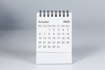 Minimalistic photo of a desk calendar displaying October 2025. Clean and professional design, suitable for topics like planning, organization, and productivity.