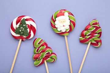 Christmas Candy on purple background. Sweet lollipop