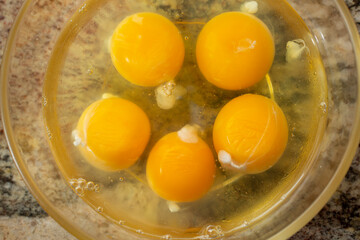 A top down view of a bowl of eggs.