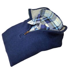 blue lambswool half zip sweater with blue checked flannel shirt, folded, isolated on white background © Alisa