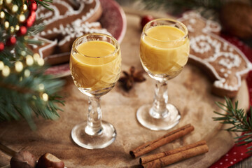 Two shot glasses of Eiecognac with spices and gingerbread Christmas cookies