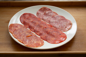 A view of a variety of salami on a plate.
