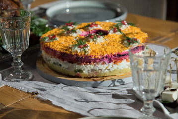 Herring salad with a fur coat on a festive table, side view