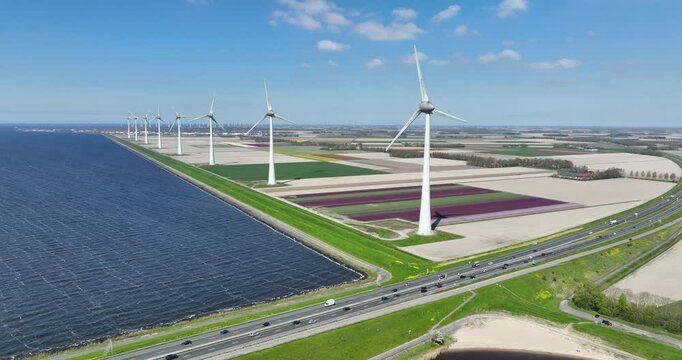 Aerial drone video of dutch wind turbines, dutch energy power and electricty generation in the spring time.