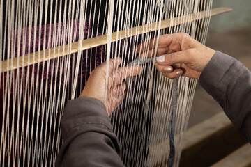 Person weaving on a loom