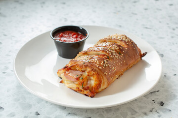 A view of a ham and cheese stromboli.