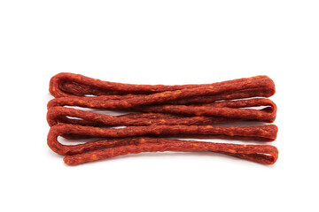 Kabanos. Pile of mini smoked dry-cured sausages isolated on a white background. Meat products and delicacies. Top view.	