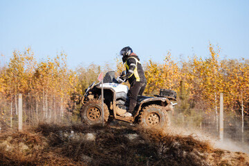 Quad bike. Cross-country quad bike, extreme sports. ATV Bike speed. Man riding ATV vehicle on off road track. People aoutdoor sport activities theme.