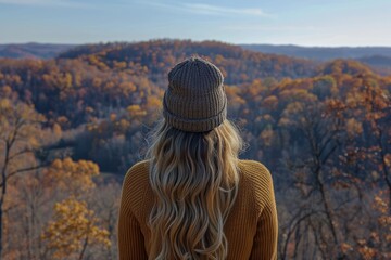 Woman in Knit Beanie Contemplates a Scenic Autumn Forest Panorama from a Hilltop Viewpoint