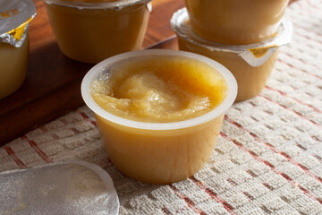 A view of an open container of apple sauce.