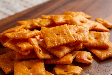 A view of a pile of popular cheesy crackers.