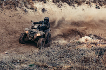 Fototapeta premium Quad bike. Cross-country quad bike, extreme sports. ATV Bike speed. Man riding ATV vehicle on off road track. People aoutdoor sport activities theme.