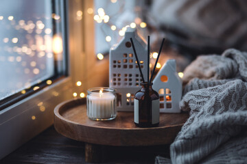 Christmas home aromatherapy. Aroma diffuser with pine extract, organic essential oil, vanilla, gingerbread cookies, candles on wooden table. Cozy atmosphere, holiday spirit. Winter inspiration