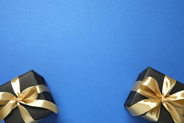 Beautiful gift boxes tied with bows on color background 