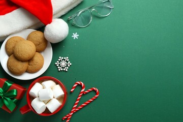 Festive Christmas composition with Santa hat, cookies and hot cocoa with marshmallows on color...