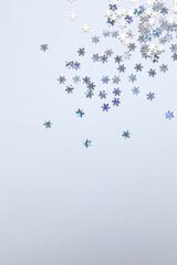Beautiful silver confetti on a white background