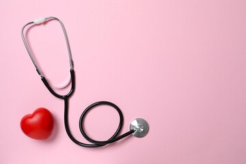 Stethoscope on color background, top view