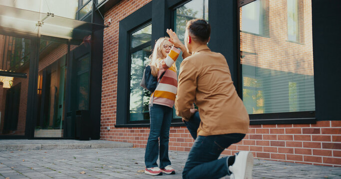 Father and Daughter talking and Giving high five to each other. Getting ready for trip back home.