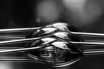 close up of  spoons reflected on mirror
