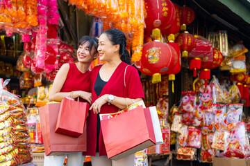 Happy Asian family celebration Chinese lunar new year festival together. Mother and daughter in red...