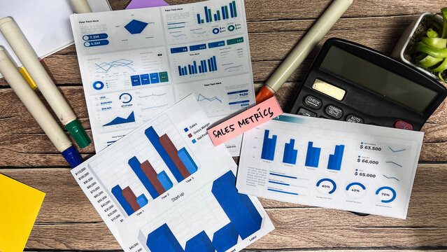 Concept of Sales Metrics write on sticky notes isolated on Wooden Table.