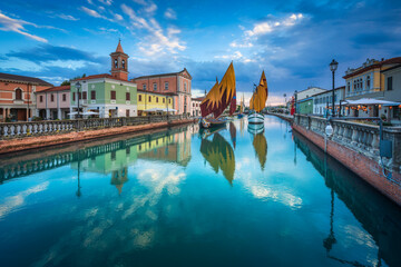 Cesenatico canal, historic sailboats and church. Romagna, Italy