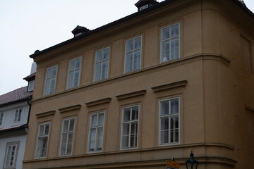 The facade of a classic urban building features a multitude of windows showcasing its architectural beauty
