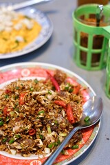 A dish of rice with stir-fried crab curry and chilli and salt fried pork belly at Chula 50 Kitchen in Silom, Bang Rak - Bangkok Thailand