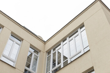 A corner view of a sleek and contemporary building featuring large windows and clean architectural lines