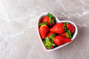 Fresh strawberries in heart bowl
