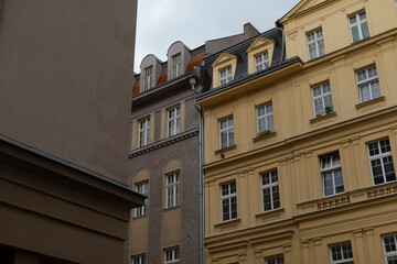 Historic buildings located in an urban setting characterized by muted tones and a cloudy backdrop