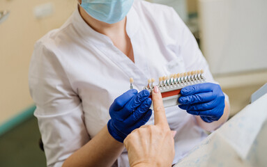 Dentist consulting patient on tooth shade selection for a natural and perfect smile restoration
