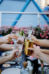 Friends toasting with drinks in a festive outdoor gathering, celebrating togetherness and joy