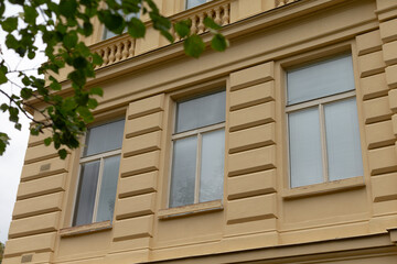 The windows are set against a textured wall background, showcasing the historic allure of the building