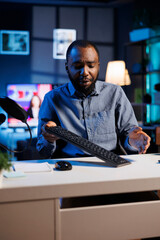 African american entertainer presenting keyboard from brand sponsoring video, urging viewers to buy it. Man does influencer marketing by advertising computer peripherals to audience