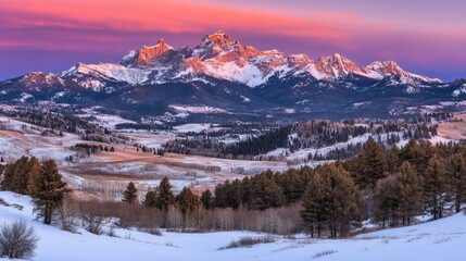 Obraz premium Majestic Snow-Covered Mountain Range at Sunset with Colorful Sky