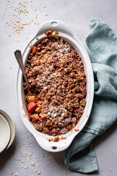 Apple rhubarb crisp in an oval baking dish