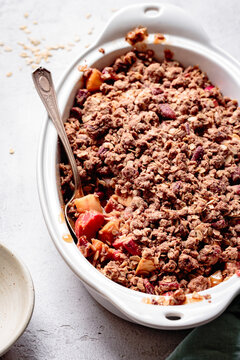 Apple rhubarb crisp in an oval baking dish