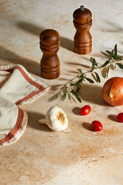 Kitchen Still Life with salt and pepper shakers, garlic, onion and tomatoes.