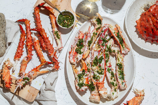 Delicious crab legs garnished with fresh herbs and garlic serve as the focal point of this mouth-watering dish. Paired with white wine.